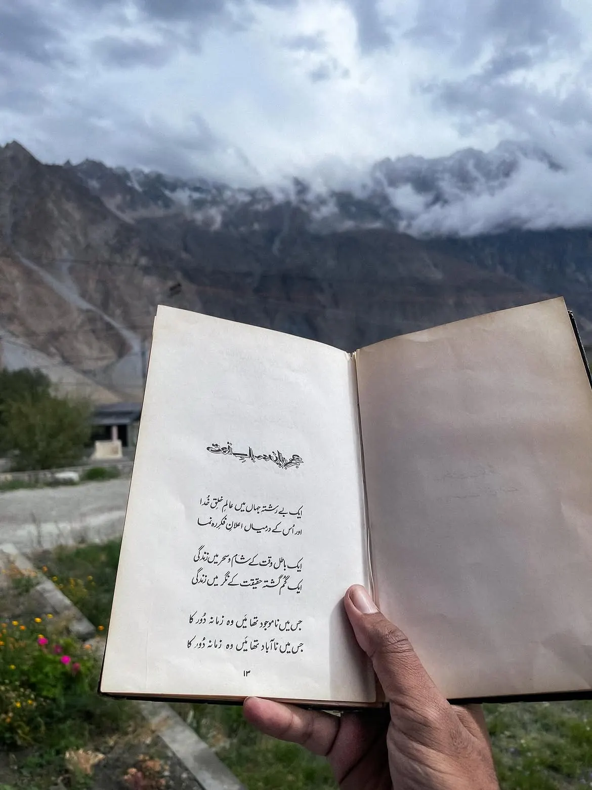 Travel reading with mountains in the background in northern Pakistan