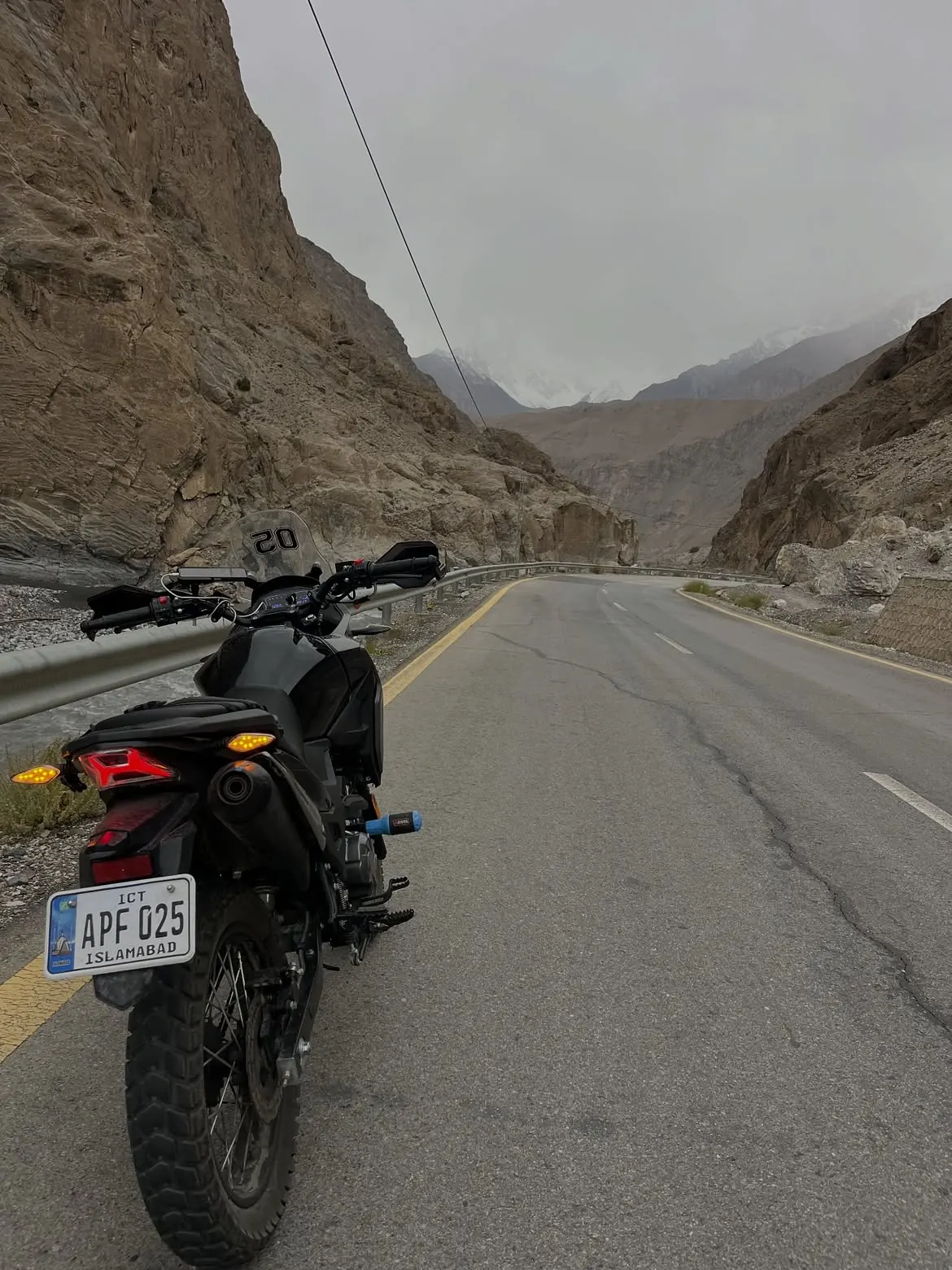 Loaded motorcycle on a mountain road in Pakistan